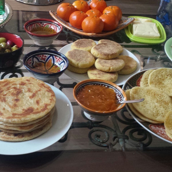 Moroccan breakfast with mssemen, baghrir, harcha, argan oil, fruits