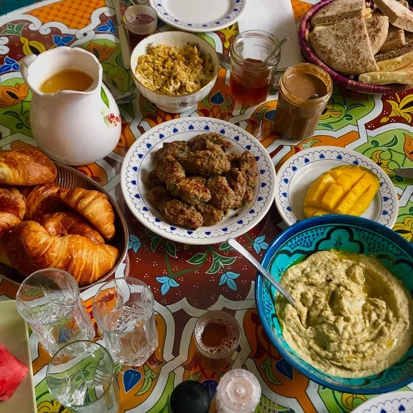 Moroccan breakfast with kefta, houmous, grilled eggplant, homemade bread